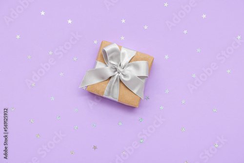 Sequins and gift for Women's Day celebration on lilac background
