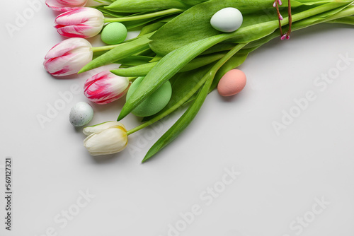 Bouquet of beautiful tulip flowers and Easter eggs isolated on white background