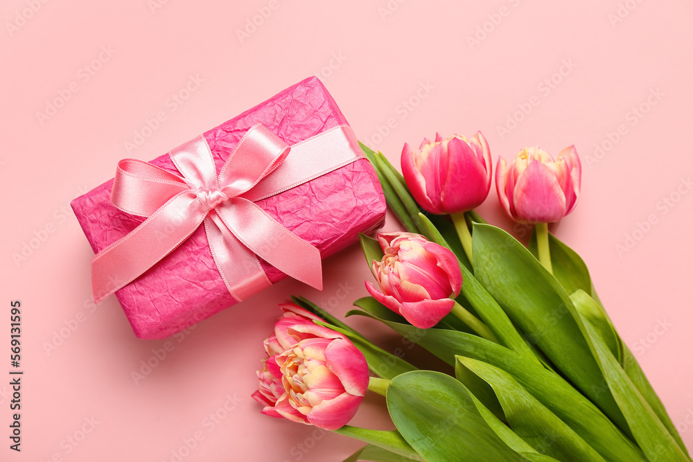 Gift box and beautiful tulip flowers on pink background. Hello spring Gift box and beautiful tulip flowers on pink background. Hello spring