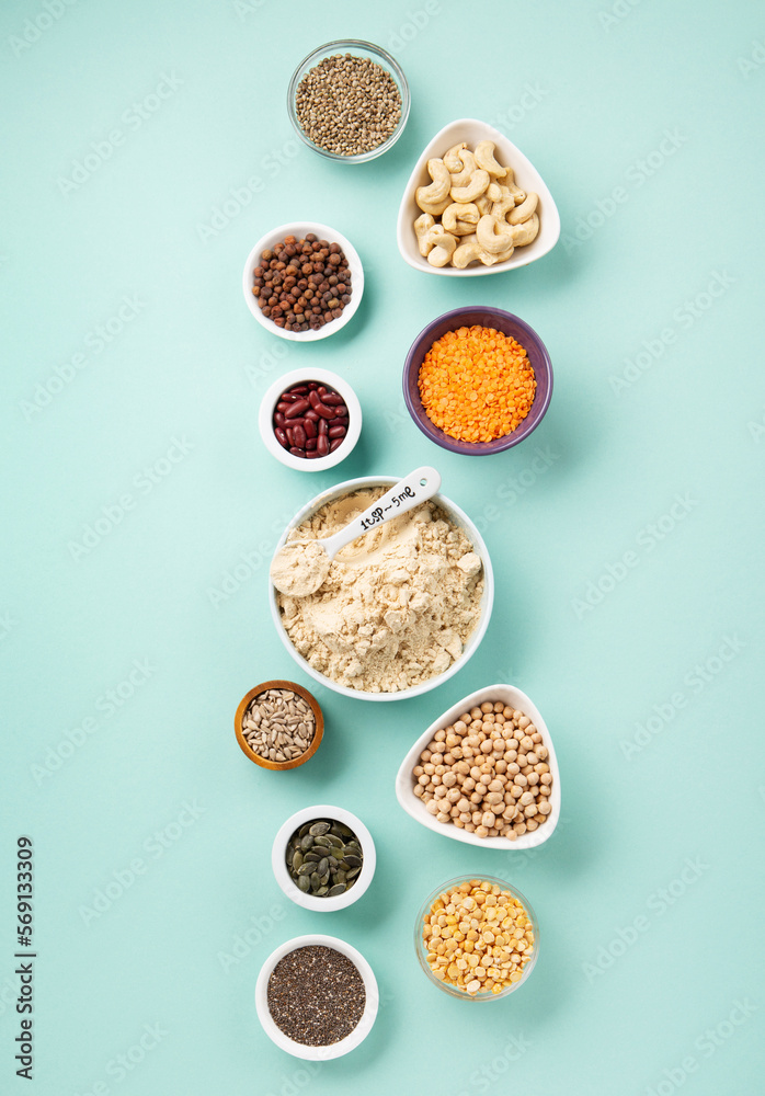 Healthy Dry Pea Protein Powder and Plant Based Protein Food (legumes, lentils, beans, seeds) on Blue Green Background. Healthy Dry Pea Protein Powder and Plant Based Protein Food (legumes, lentils, beans, seeds) on Blue Green Background.
