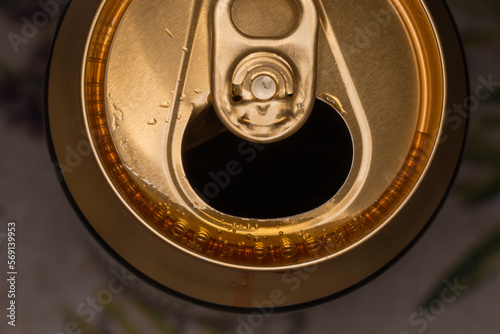 Top view of open beer can on a blurred background