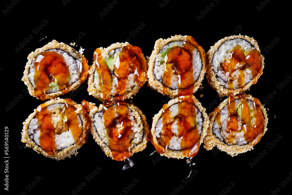 hot sushi roll tempura with eel shrimp crab salmon cream cheese cucumber avocado unagi on a black mirror background hot sushi roll tempura with eel shrimp crab salmon cream cheese cucumber avocado unagi on a black mirror background