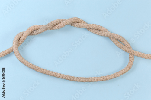 Rope knot Threefold overhand knot on a blue background photo