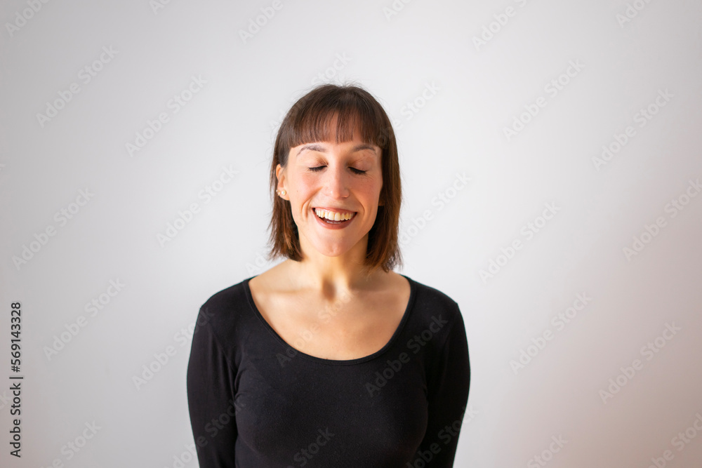 Portrait of a girl on white background. Brown short hair girl. Girl smiling with eyes closed Portrait of a girl on white background. Brown short hair girl. Girl smiling with eyes closed