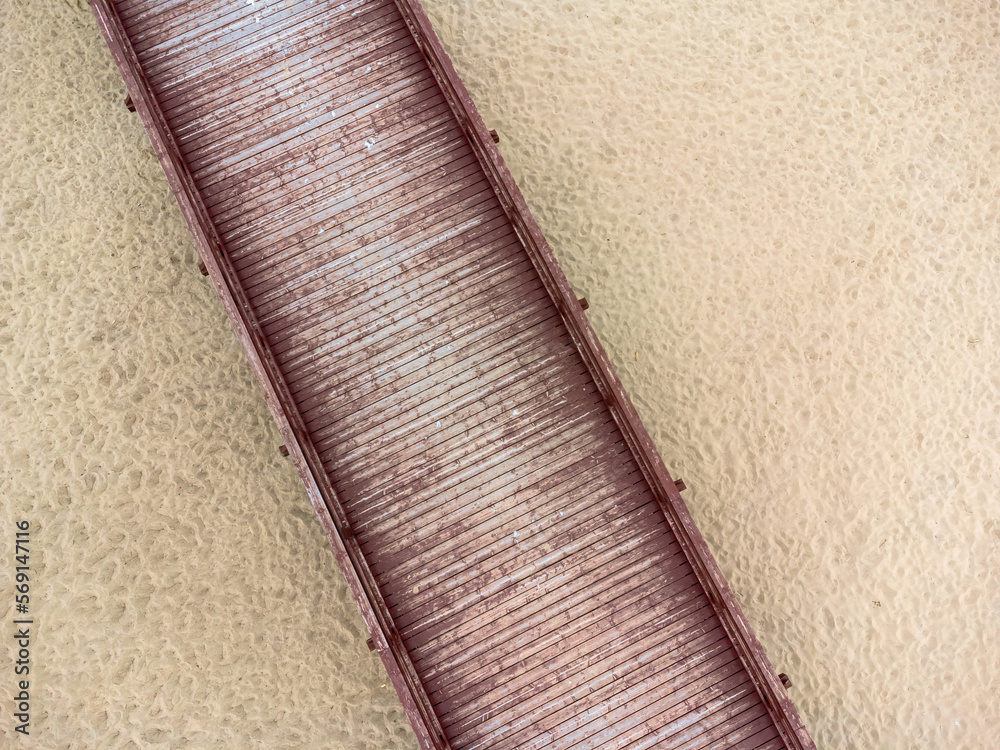 Aerial view landscape. Wooden platform, footbridge, path, sand, beach.