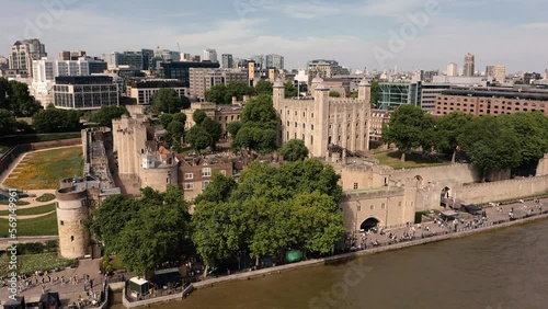 Drone shot circling The Tower of London on a hot Summers day over the River Thames bustling with Tourists photo