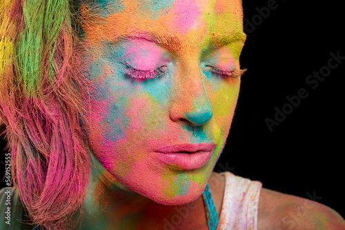 Beautiful woman covered in rainbow colored powder. Holi festival. Beauty spring concept