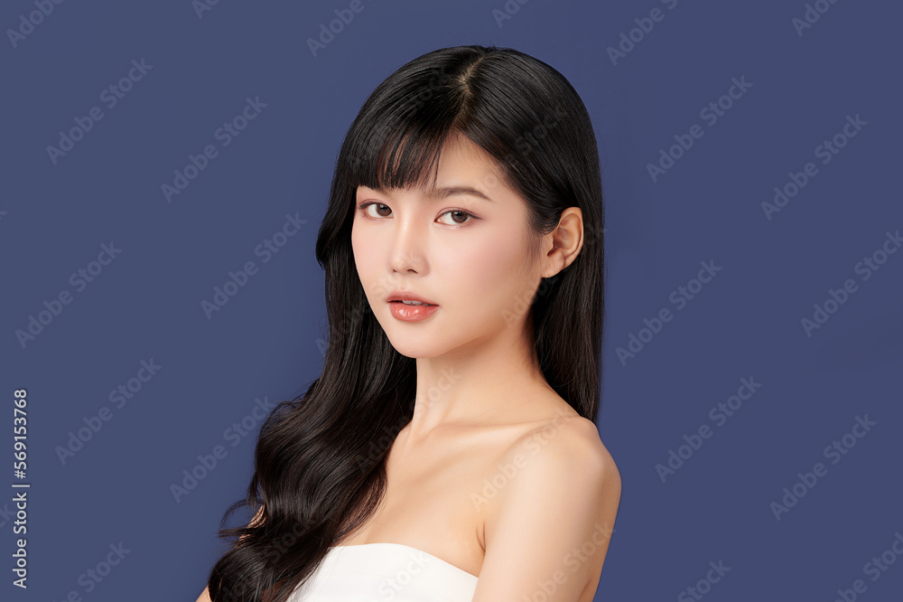 Fototapeta premium Beautiful young asian woman with clean fresh skin on blue background, Face care, Facial treatment, Cosmetology, beauty and spa, Asian women portrait.