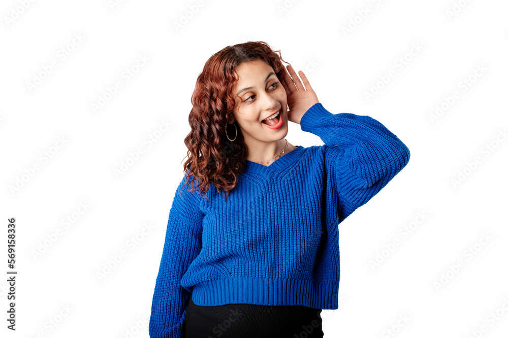 Beautiful woman wearing blue knitted sweater standing isolated over white background bewildered, eavesdropping or on what is being said in secret. Astonished eavesdrop secret rumor listen.