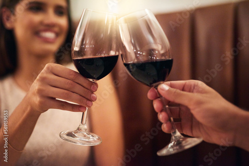 Hand, wine glasses and couple in restaurant for achievement, celebration or romance on Valentines day. Romantic, man or happy woman with zoom, cheers or alcohol for date, affection or toast with love
