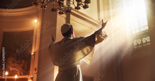 Canvas Print The Pope Stands Raises his Hands In A Gesture Of Universal Blessing, as He is being Luminated by the Guidance of God