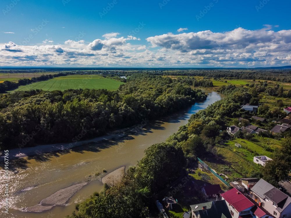 Fototapeta premium Aerial vIew of Zhudachiv city by drone. Summer Ukraine Lviv region, West Ukraine. River.