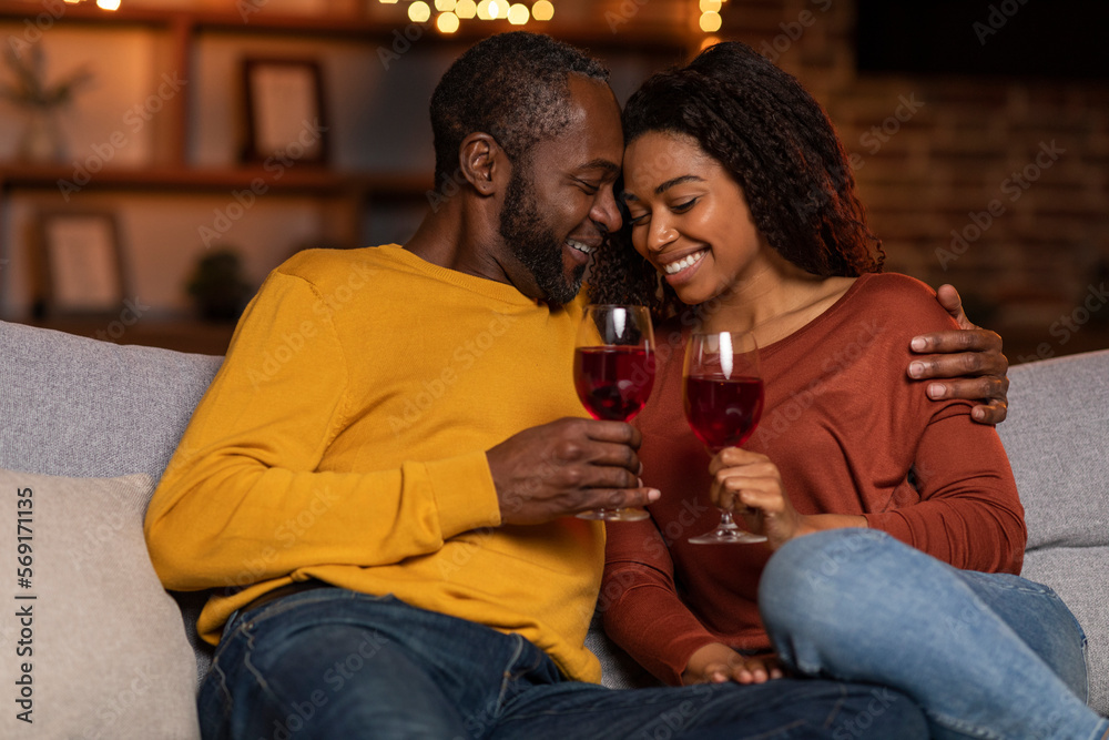 Loving black husband hugging his pretty wife, home interior Loving black husband hugging his pretty wife, home interior