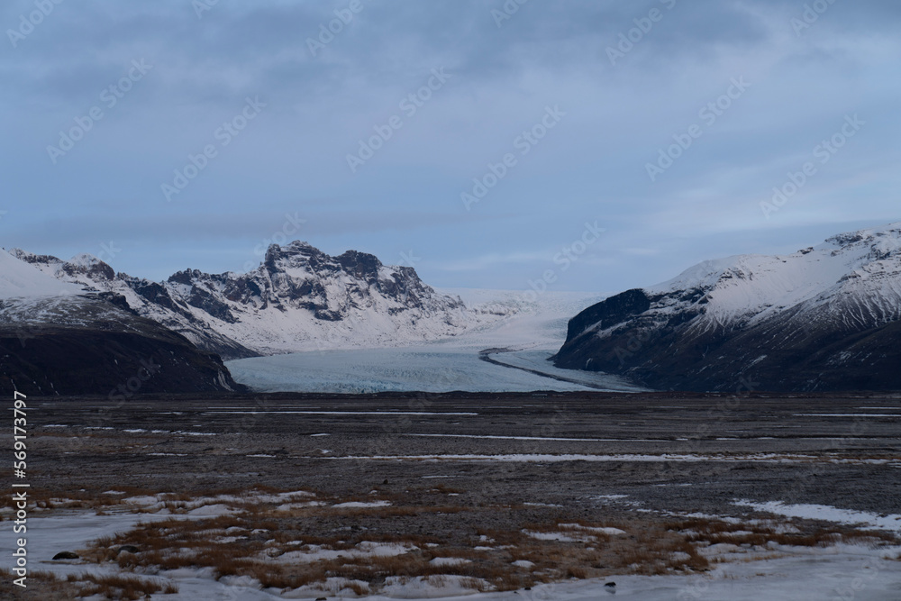 Glaciers cascade down snow-capped mountain canyons and plains carved by volcanic activity. Glaciers cascade down snow-capped mountain canyons and plains carved by volcanic activity.