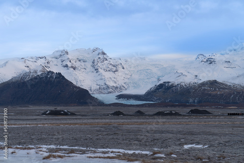 Glaciers cascade down snow-capped mountain canyons and plains carved by volcanic activity.