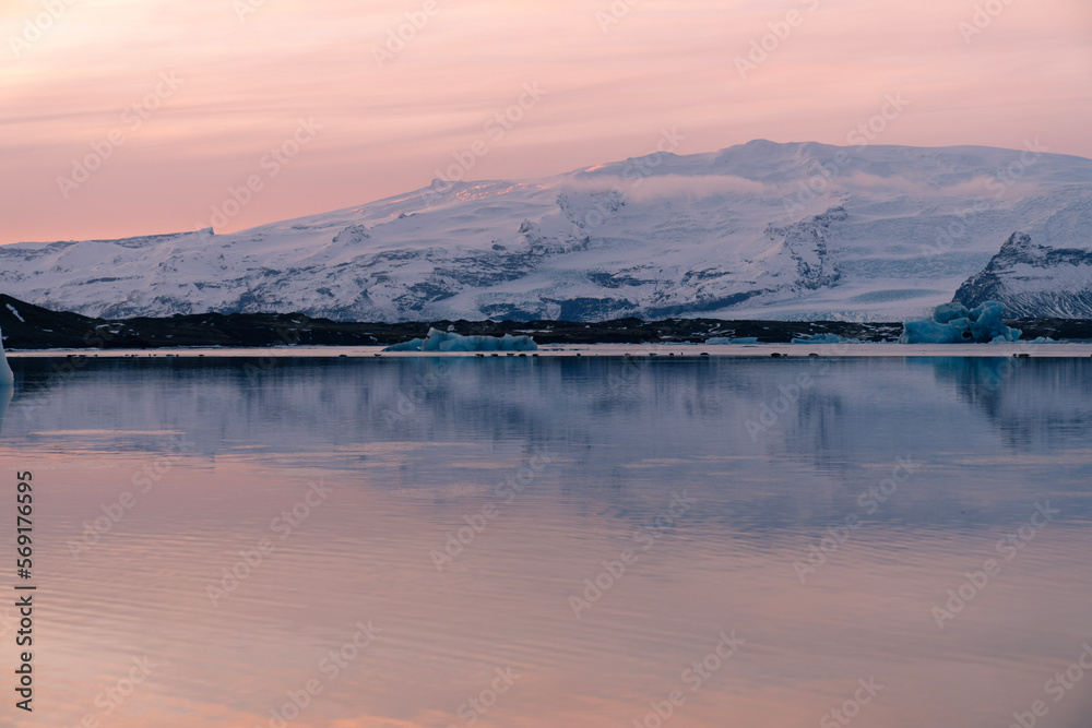 Fototapeta premium iceberg in the water, Floating Glaciers, beautiful pink sunset
