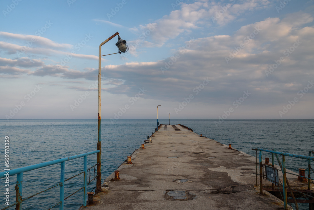 Old empty pier in blue sea. Koktebel. Crimea