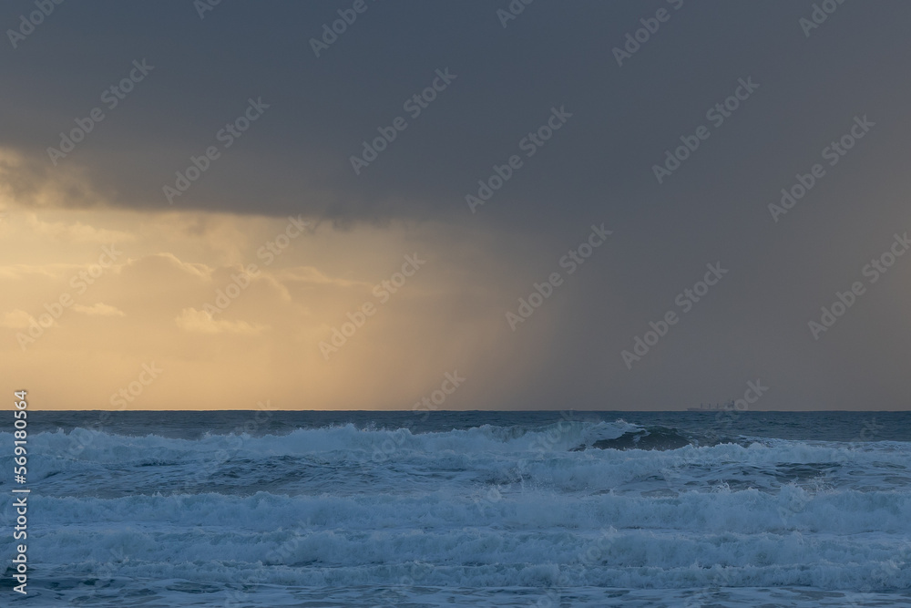 White sea waves and cloudy skyscape in the evening
