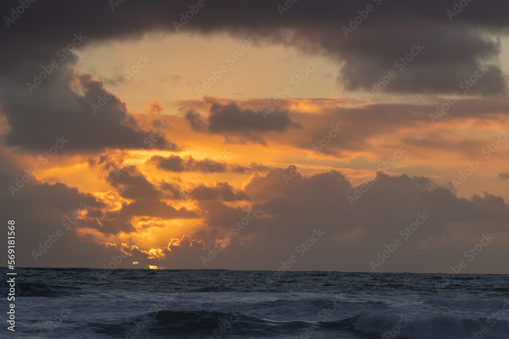 Cloudy sunset over the blue sea