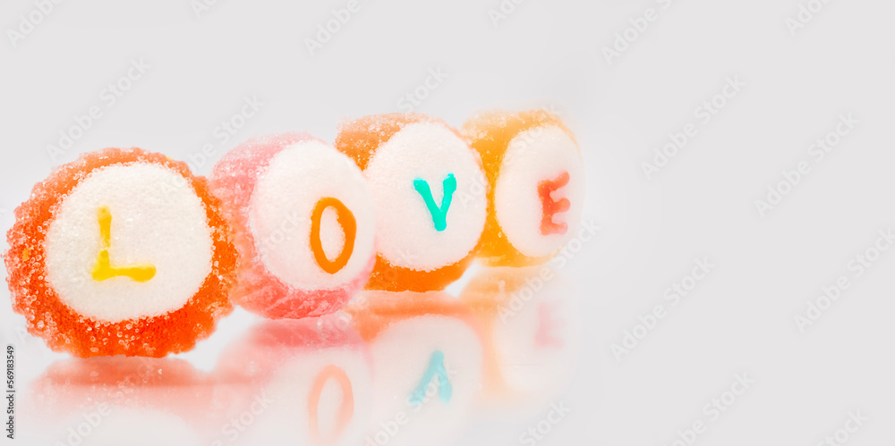 Naklejka premium love,text in candy on white background.Valentine's day sweet and sugar.