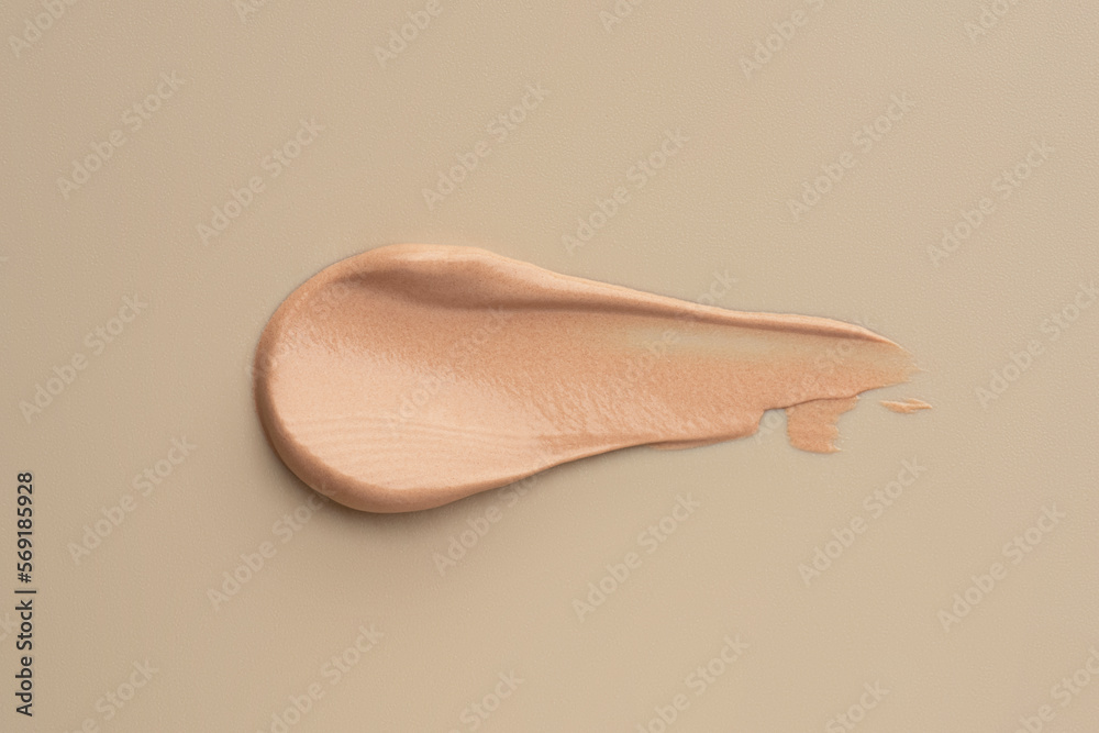 Fototapeta premium The texture of the foundation on a beige background