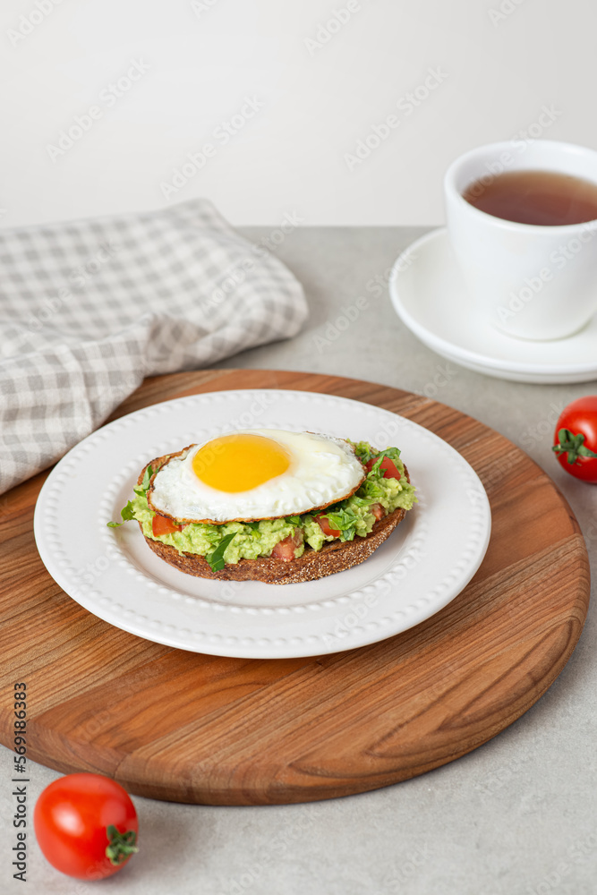 Toast with guacamole and avocado in a white plate on the table Toast with guacamole and avocado in a white plate on the table