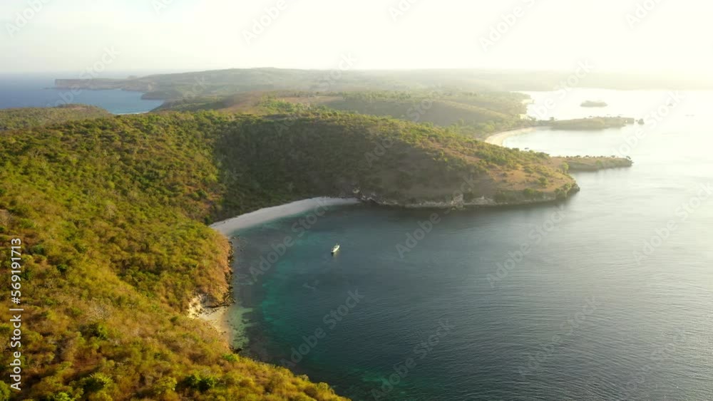 Aerial Lockdown Beautiful View Of Green Mountain Island, Drone Flying By Rippled Sea - Lombok, Indonesia Aerial Lockdown Beautiful View Of Green Mountain Island, Drone Flying By Rippled Sea - Lombok, Indonesia