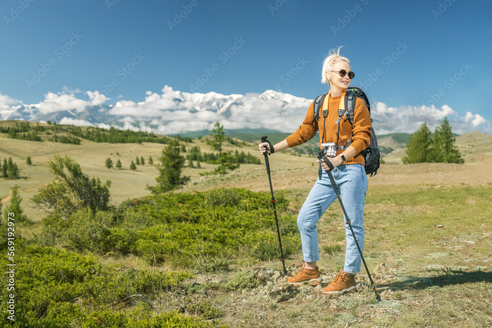 A beautiful caucasian woman with backpack and enjoy summer sunny day in mountains. Travel lifestyle concept adventure summer vacations outdoor wildlife.