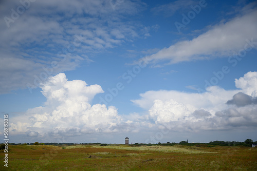 Dutch field landscape with clouds and water tower of Ter Heijde.