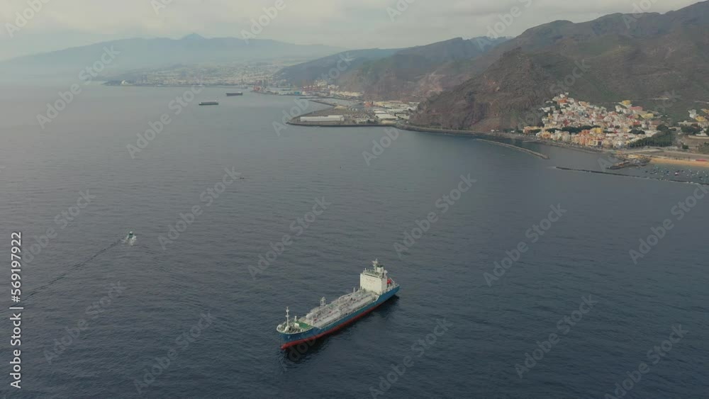 upper view tanker in calm harbor at resort and mountains upper view tanker in calm harbor at resort and mountains