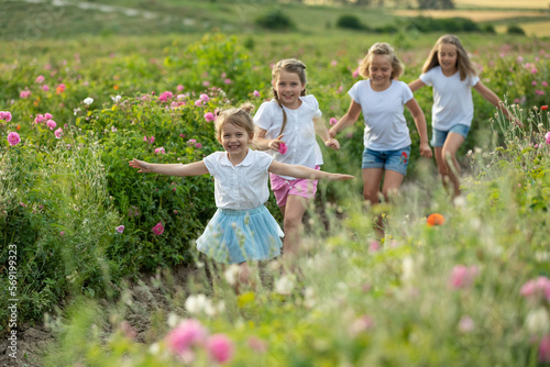 Children play in nature. The girls are having fun running around. photo