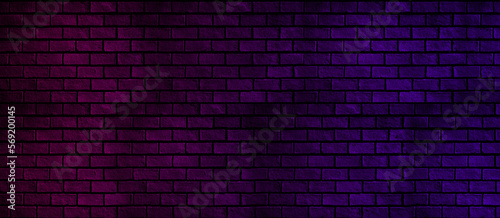 Abstract panorama of brick wall with blue and pink neon light for pattern background. Basic dark and color background concept.