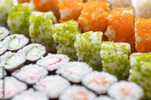 Close up of maki sushi rolls with cucumber, surimi, fish roe