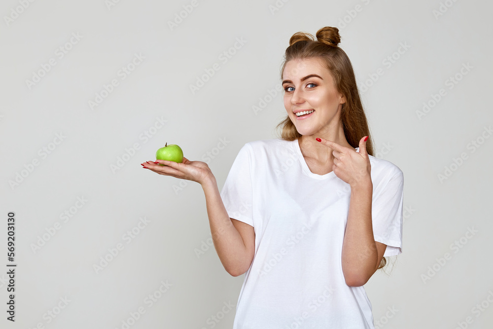 girl holding green apple on studio background girl holding green apple on studio background