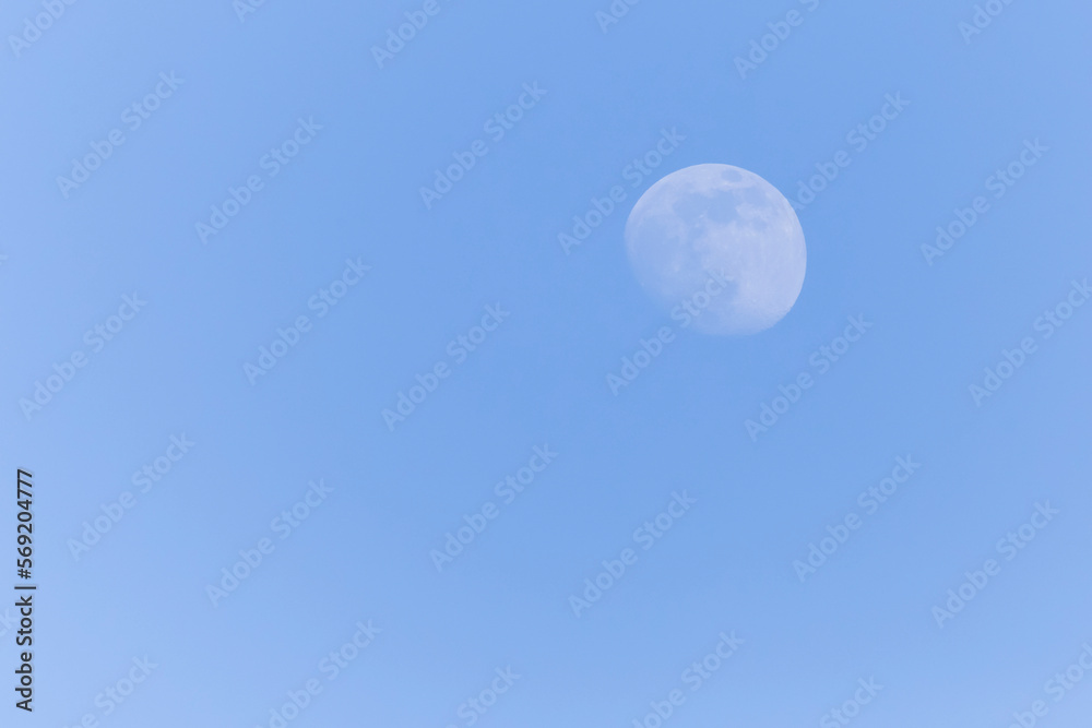 view on waxing gibbous Moon in a blue sky view on waxing gibbous Moon in a blue sky
