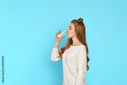 beautiful woman drinks water from a glass