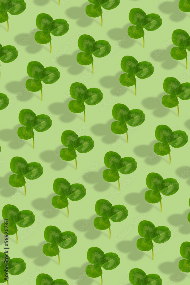 Clover leaf pattern on colored background. Abstract vertical background for St. Patrick's Day Clover leaf pattern on colored background. Abstract vertical background for St. Patrick's Day