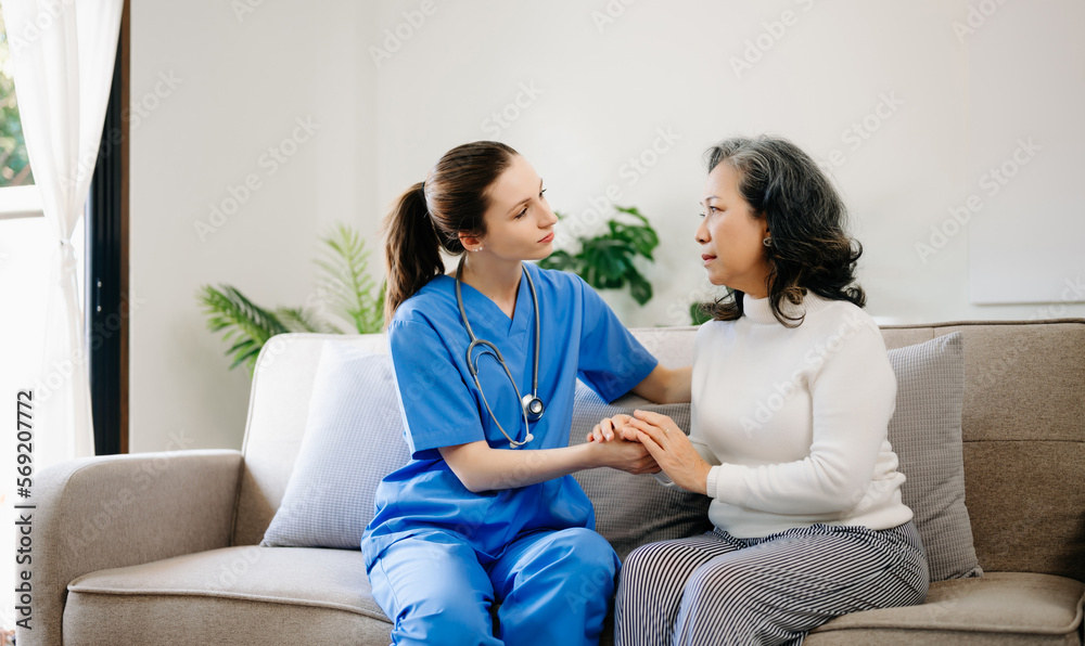 Asian female hands touching old female hand Helping hands take care of the elderly concept in hospital. Asian female hands touching old female hand Helping hands take care of the elderly concept in hospital.