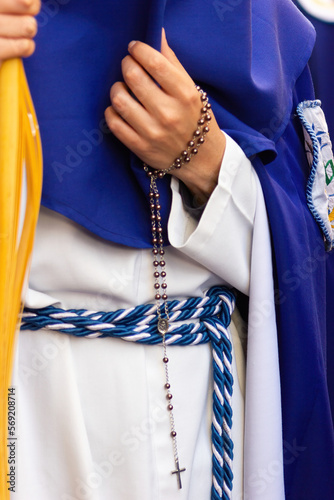 Penitent or Nazarene carrying a rosary during the Holy Week procession.