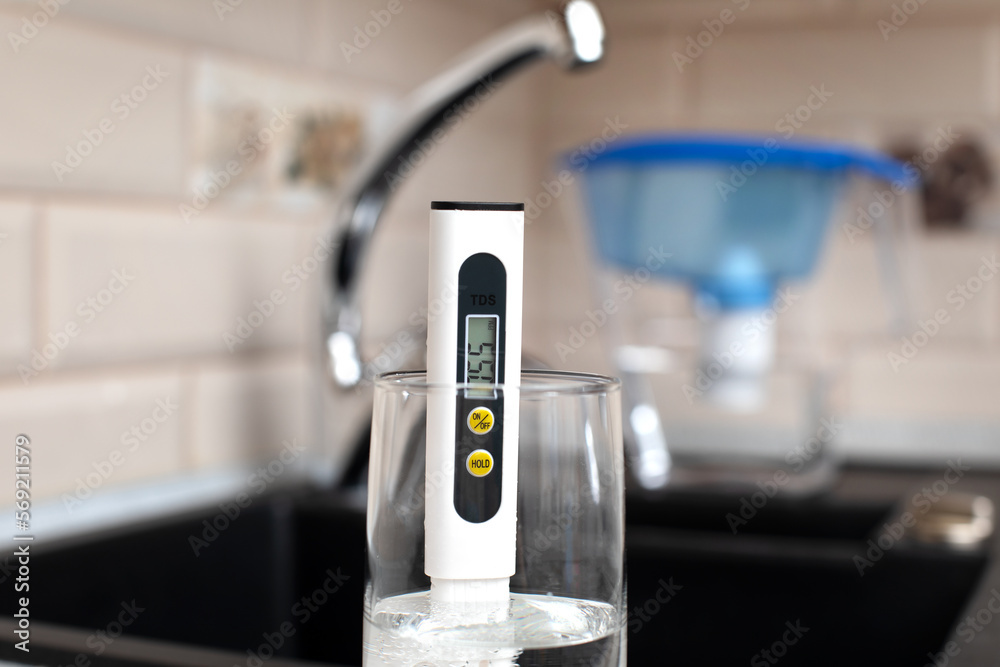 Tds meter for measuring water hardness is in the kitchen next to the