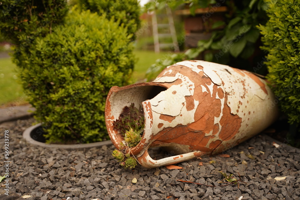 Traditional Greek vase. Flower vase in the city. Urban architecture