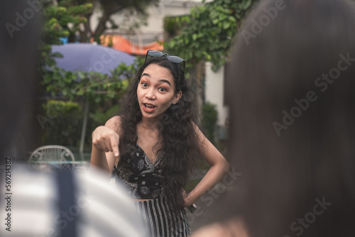 Photography An self-entitled and mean young woman lectures and berates two poor women about their looks and social status
