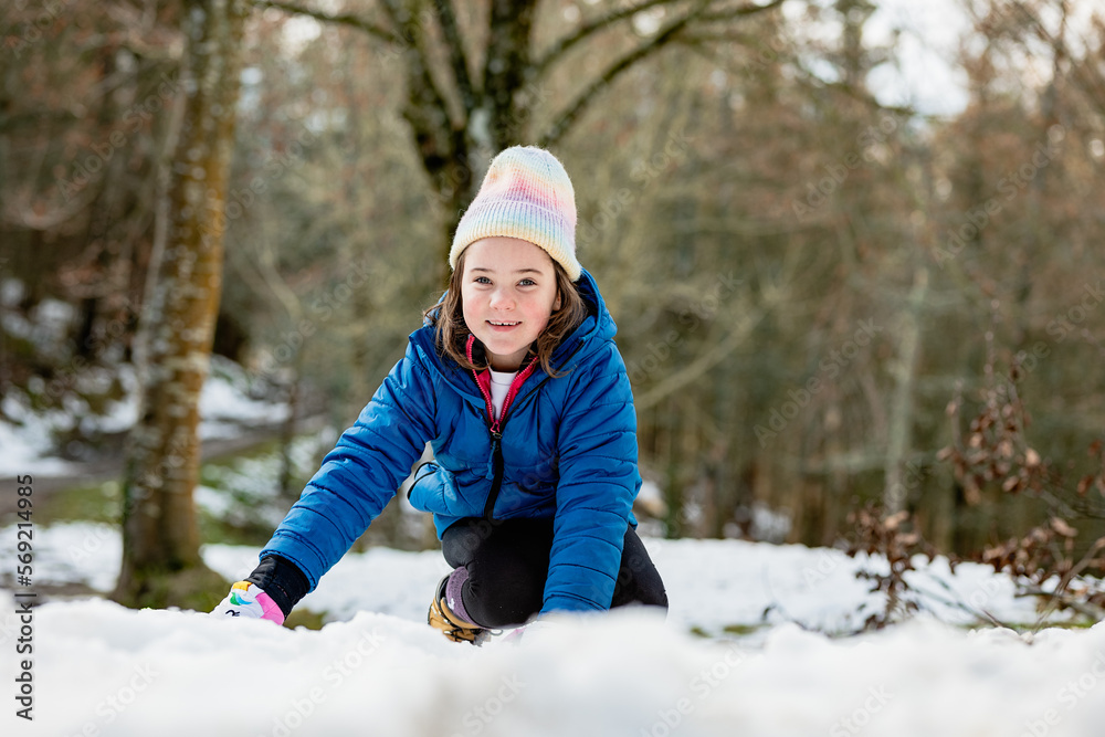 Cheerful girl playing with snow Cheerful girl playing with snow