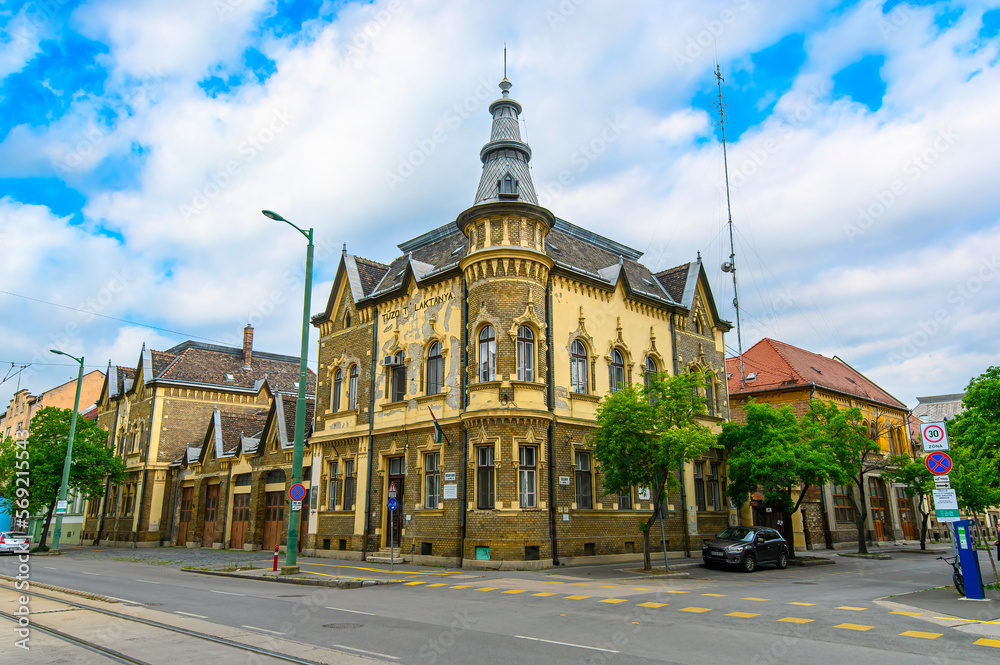 Front view the facade of beautiful old building with old sculptures in the city center of Szeged, Hungary Front view the facade of beautiful old building with old sculptures in the city center of Szeged, Hungary