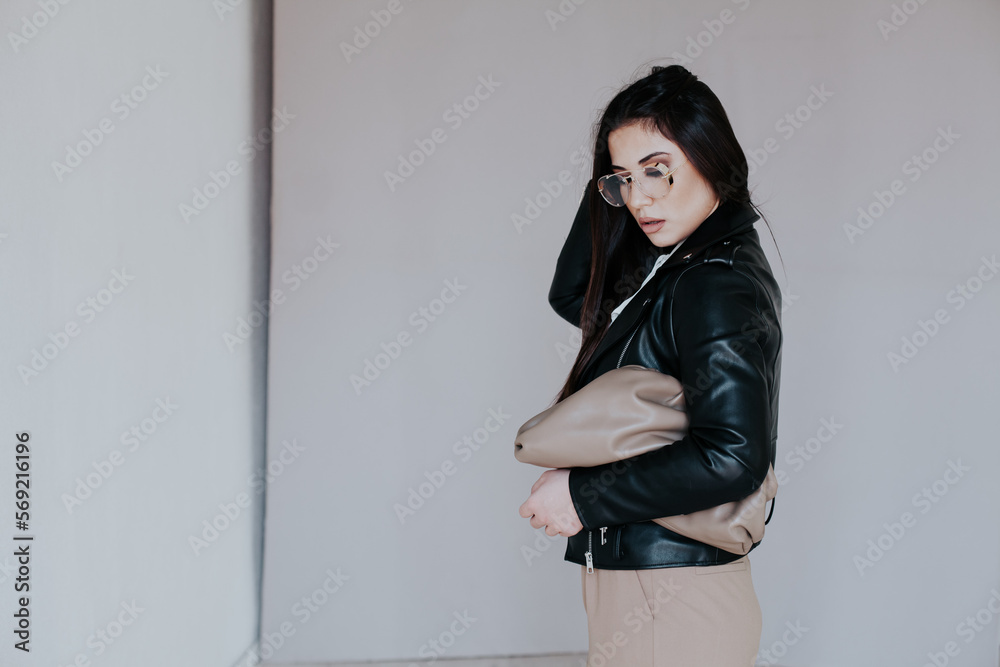 woman brunette in sunglasses with beige women's bag woman brunette in sunglasses with beige women's bag