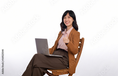 Happy young business asian woman smiling. While her using laptop sitting on wooden chair isolate on white background