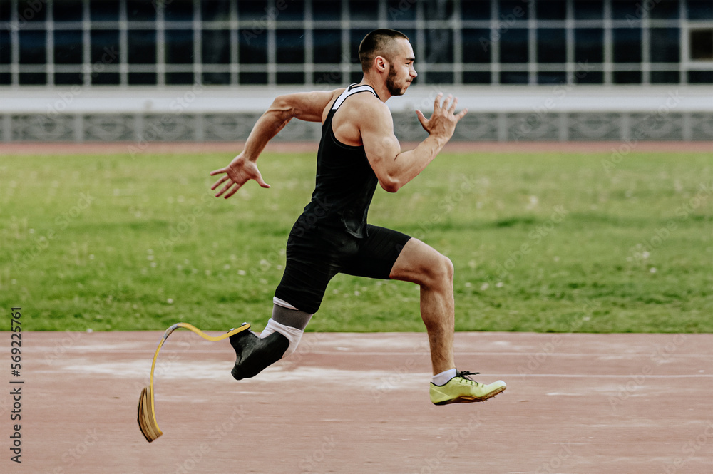 male paraathlete running in track stadium