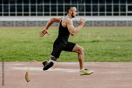 male paraathlete running in track stadium