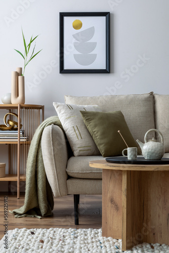 Creative composition of stylish living room with beige sofa with pillow, wooden coffee table, geometric small table. Mock up poster. Home decor. Template.