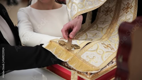Close-up of the priest and the hands of the bride and groom in a Christian church. photo